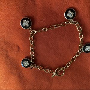 Gold style colored bracelet with black charms.